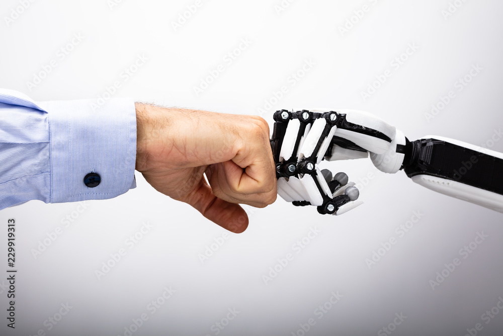 Human Hand And Robot Making Fist Bump